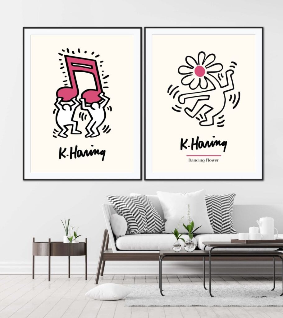 Two Keith Haring cartoons hanging on a wall above a couch