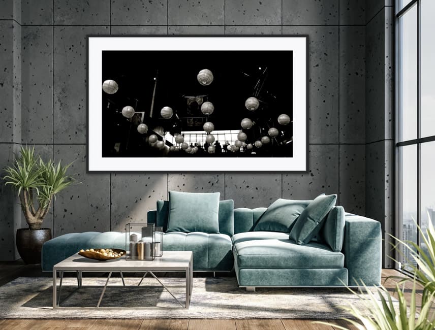 Framed black and white photo of the round lamps adorning the ceiling of Little Creatures Brewery in Fremantle Australia. The picture is hanging on a wall in a lounge area