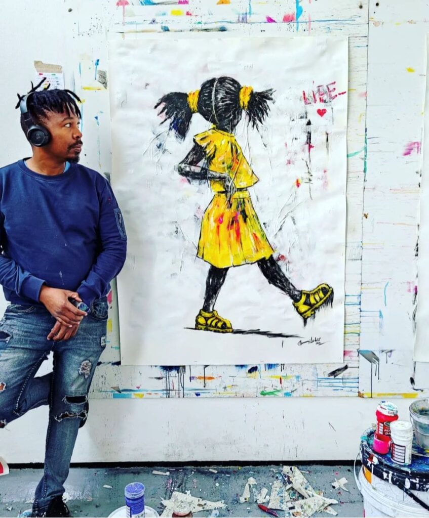 Picture of Semi Lubisi standing next to one of his paintings