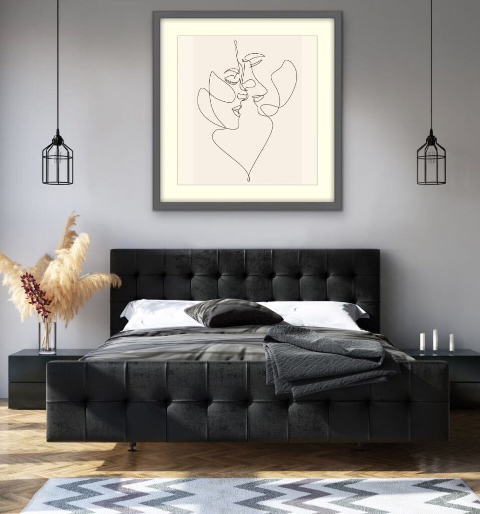Framed abstract art on wall above bed